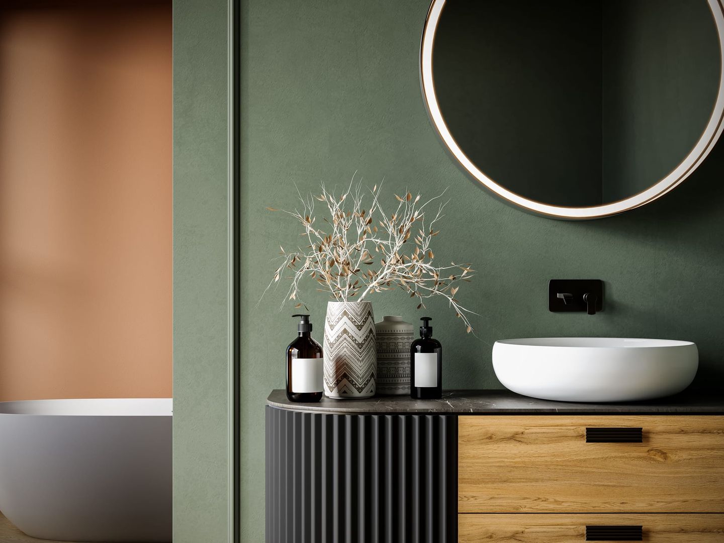 Modernes Badezimmer mit grün gestrichener Wand, rundem beleuchtetem Spiegel, weißem Aufsatzwaschbecken und dekorativen Flaschen sowie einer Vase mit trockenen Zweigen