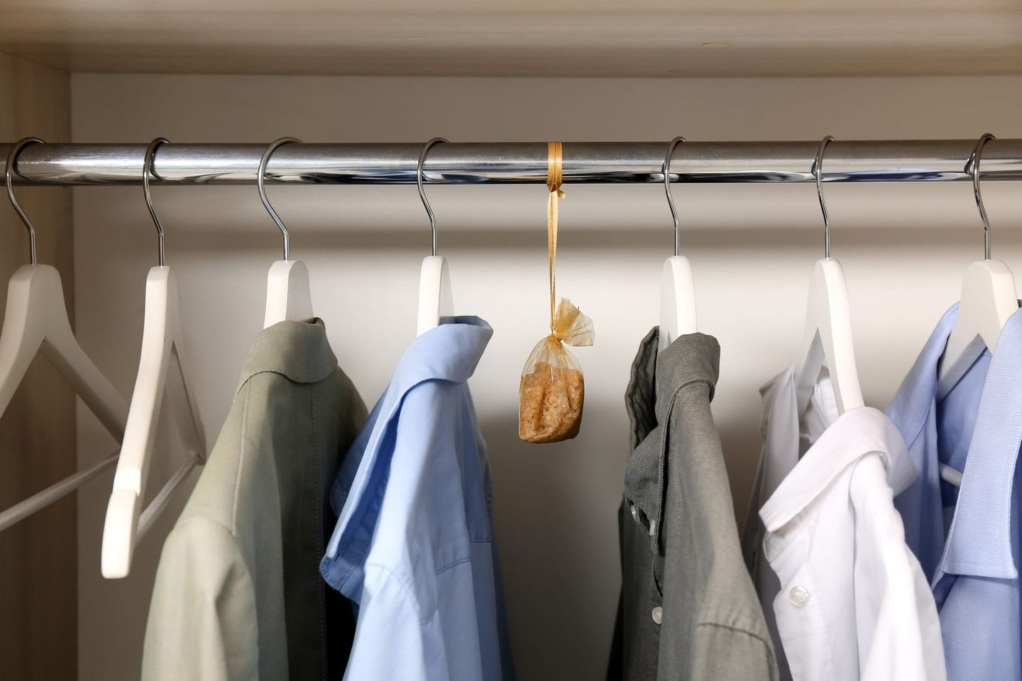 Kleiderschrank mit Hemden und einem aufgehängten Duftsäckchen gegen Motten.